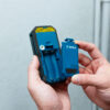 The open battery compartment of a Bosch GLM 50-27 CG laser measure.